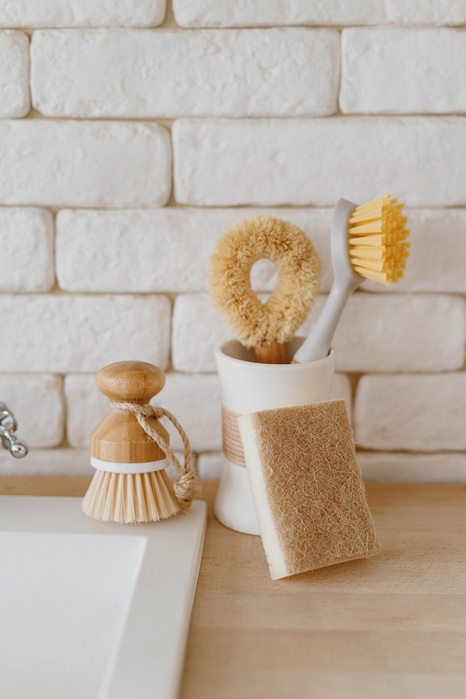Image of wooden cleaning scrub brushes on a sink